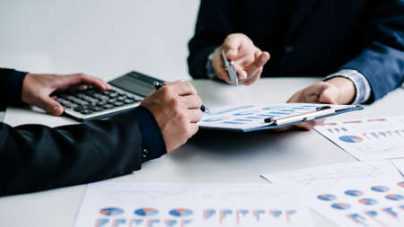 Business colleagues are discussing Financial information in collaboration in the office.の写真素材