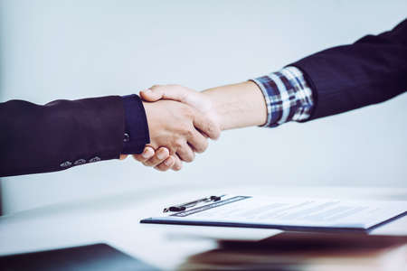 Shaking hands business people in office, business communication and marketing concept.の写真素材