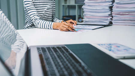 Business financial advisor woman planning annual budget and review paper report and tax.の写真素材