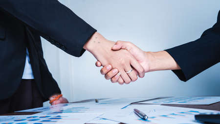 Shaking hands at meeting of business women teamwork success concept.の写真素材