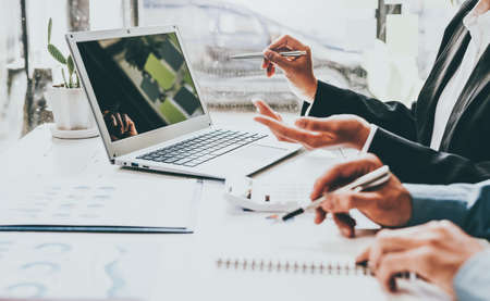 Business team hands working with document at working with plan on office desk, blank screen laptop.の写真素材