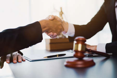 Businessman shaking hands to seal a deal with his partner lawyers or attorneys discussing a contract agreement.の写真素材