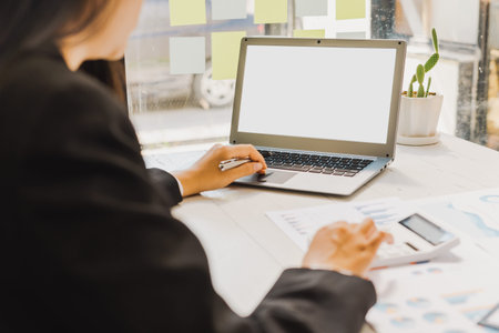 Blank screen laptop, Close up Business woman using calculator and laptop for do math finance on...