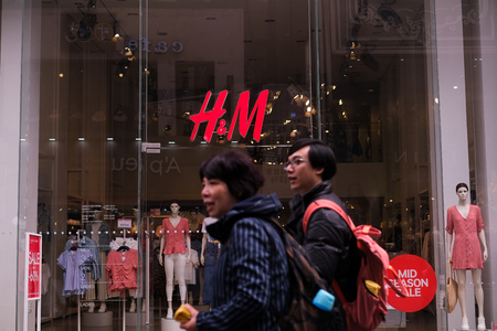 MYEONGDONG, SEOUL - 27th March 2019 : Pedestrians , locals, foreigners and tourist walking the the street of Myeongdong, one of Seoul most visited district. People are passing by at H&M stores.のeditorial素材