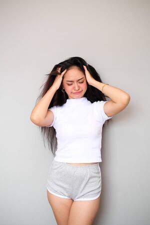 Young female Asian girl wearing a sportswear attire, shot body length, showing an angry expressionの写真素材