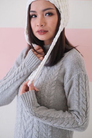 Asian girl, shot body length, is wearing a winter outfit with a cute emotion