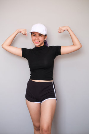 An attractive single Asian girl, shot body length, wearing sportswear with short pants