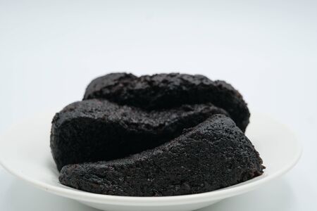 chocolate moist cake shot on a white isolated background.の写真素材