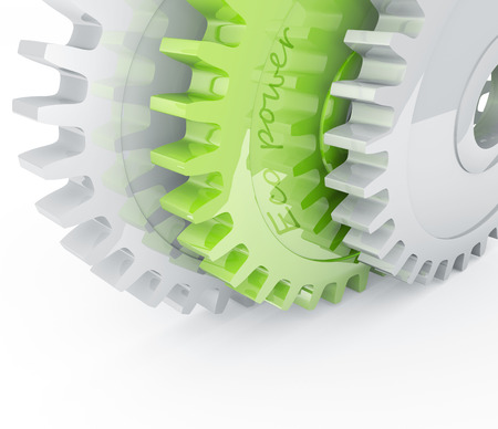 Green gear behind chrome mechanical gearsの写真素材
