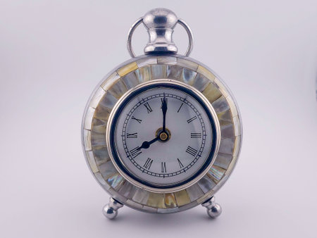 Vintage clock with pearl inlays set at 8 o'clock. The shot is taken on a white back ground.の写真素材