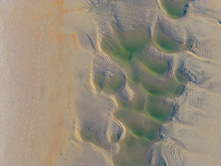 Aerial drone view of sand formations left by the storm. The verity of color make a great background. Taken from 300 ft. at Wrightsville, Beach, NCの写真素材