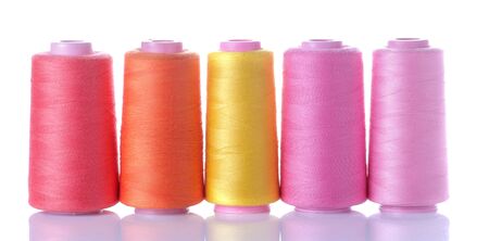 Multicolored spools with threads on white isolated background. accessories for sewingの写真素材