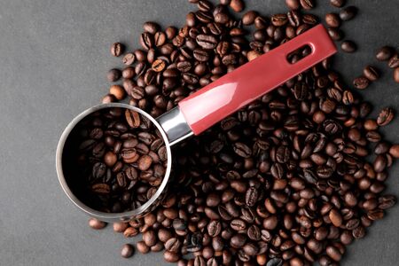 Cezve. With coffee beans inside on a black background. top viewの写真素材