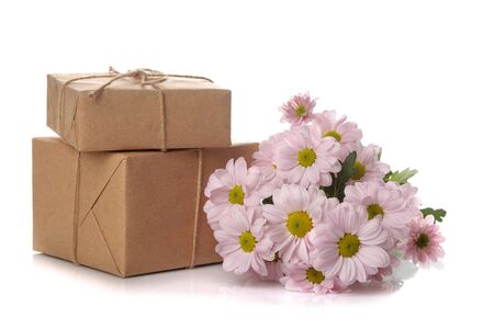 Autumn chrysanthemum flowers and gifts in kraft paper on white isolated backgroundの写真素材