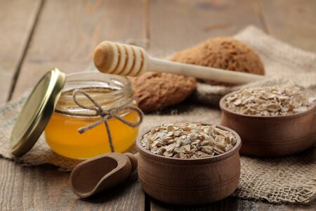 Dry oatmeal, honey and oatmeal cookies. food. healthy food. on a brown wooden table.の写真素材