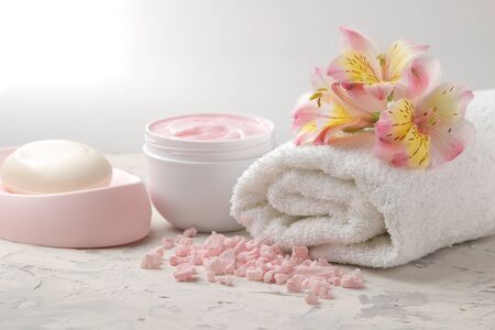 Spa composition with soap, towel and body scrub. spa concept. on a light background.の写真素材