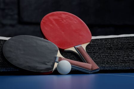 Accessories for table tennis racket and ball on a blue tennis table. Sport. Sport game.の写真素材