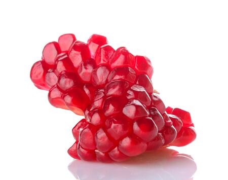 Red grains of pomegranate fruit. pomegranate center on white isolated backgroundの写真素材