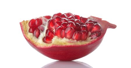 Red half pomegranate fruit with grains close up on a white isolated backgroundの写真素材