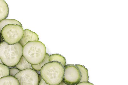 Fresh green cucumbers sliced on white isolated background. Fresh vegetables. view from aboveの写真素材