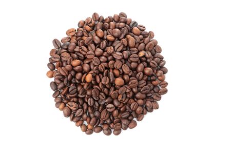 A handful of coffee beans on a white isolated background. close-up. view from above. roasted coffee beans.の写真素材