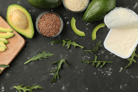Avocado, cheese, bread. ingredients for making avocado sandwiches. On a dark background. view from above.の写真素材
