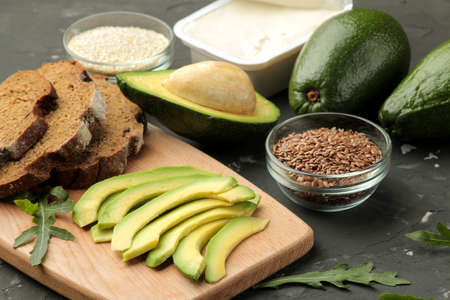 Avocado, cheese, bread. ingredients for making avocado sandwiches. On a dark background.の写真素材