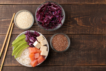 poke bowl Hawaiian food. a plate with rice, salmon, avocado, cabbage and cheese, near sesame. on a...
