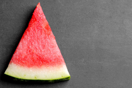 fresh ripe slices of watermelon on a black background with a place for writing close-up. top view