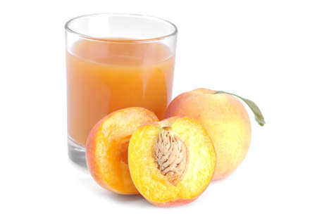 Large fresh peach with green leaf and peach halves and juice on white isolated background.の写真素材