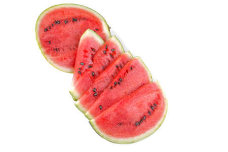 a lot of ripe red slice of watermelon with sunflower seeds closeup on white isolated backgroundの写真素材