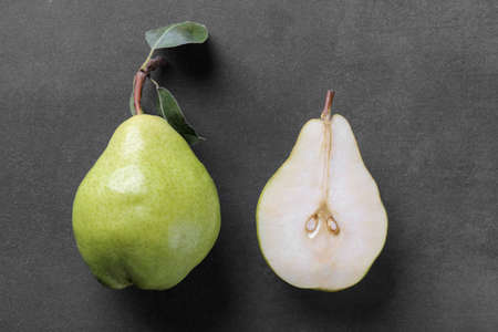 Fresh ripe pears close-up and pear in a cut-out plan on a black background. top viewの写真素材