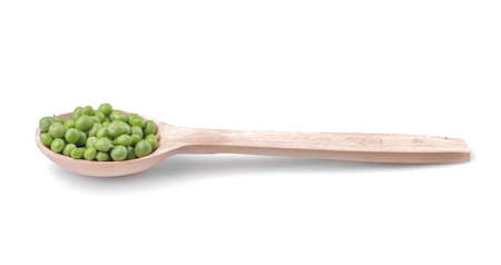 Green fresh peas in a wooden spoon on a white isolated backgroundの写真素材