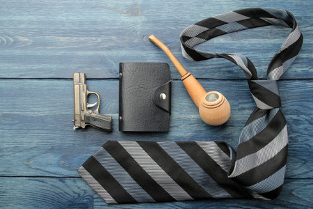 Men's Accessories. men's style. Tie, pipe, business card holder and a pistol-lighter on a blue wooden background. lay lay.の写真素材