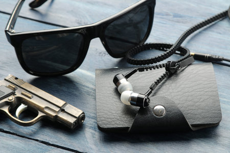 Men's Accessories. Man's style. Points, business card holder, and headphones on a blue wooden...