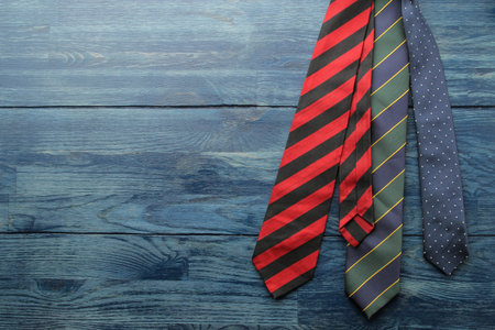Men's Accessories.men's style. various ties on blue wooden background. flat lay. with space for text