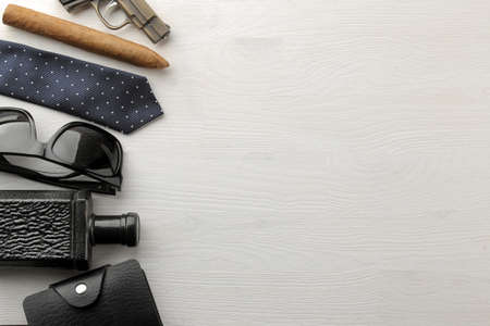 Men's Accessories. men's style. business card holder, perfume, cigar, glasses and tie on a white wooden background. flat lay. with space for text. frameの写真素材