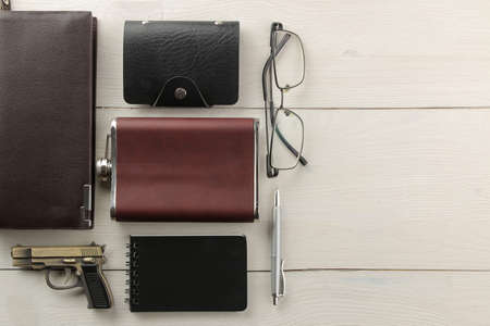 Men's Accessories. men's style. Purse, business card holder, flask, glasses, pen and notebook on a white wooden background. flat lay. with space for text. frameの写真素材