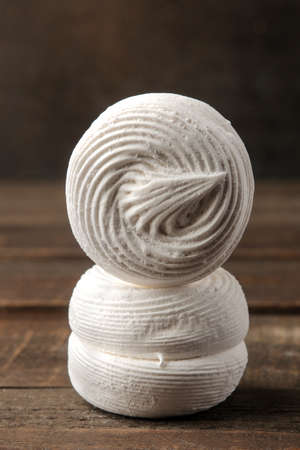 Sweet white marshmallow on a brown wooden table. Sweets. close-upの写真素材