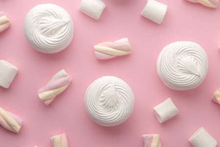 Background of sweet white marshmallows and small marshmallows on bright trendy pink background. Sweets. dessert. view from above.の写真素材