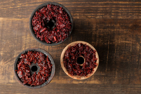Clay bowls for hookah with tobacco on a brown wooden table. hookah accessories