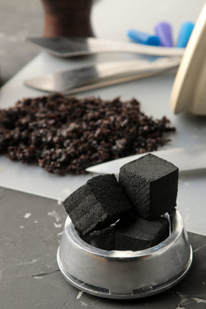 coconut charcoal for calauda hookah close-up on a dark background and various accessories for making hookah. hookah accessoriesの写真素材