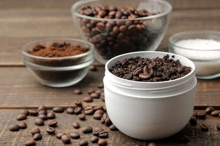 homemade coffee scrub in a white jar for the face and body and various ingredients for making scrub. spa. cosmetics. care cosmeticsの写真素材