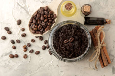 homemade coffee scrub in a jar for the face and body, and various ingredients for making scrub on a light background. spa. cosmetics. care cosmetics. view from aboveの写真素材
