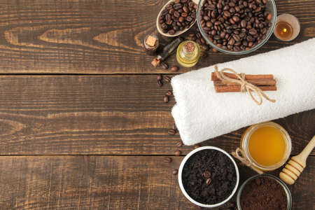 homemade coffee scrub in a white jar for the face and body and various ingredients for making scrub. spa. cosmetics. care cosmetics. top view with space for textの写真素材