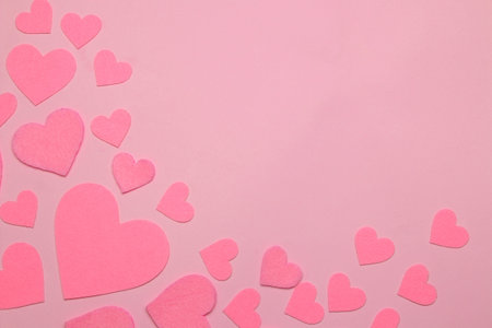 Pink hearts on a bright pink background. frame of hearts, top view with space for text