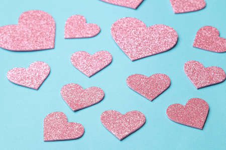 Pink hearts on a bright blue background. frame of hearts, with space for textの写真素材