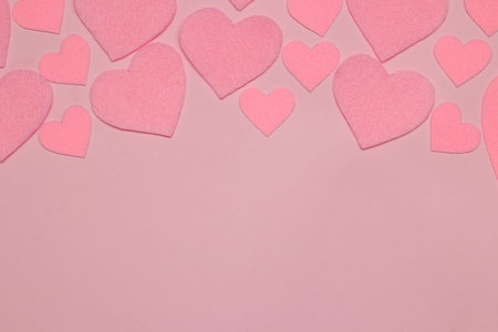 Pink hearts on a bright pink background. frame of hearts, top view with space for text