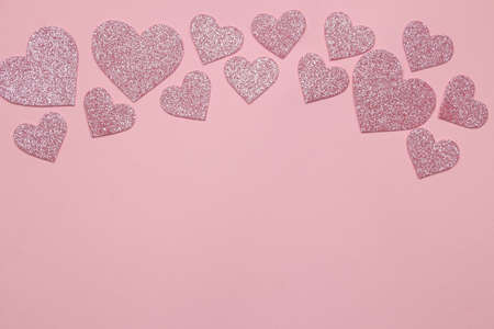 Pink hearts on a bright pink background. frame of hearts, top view with space for textの写真素材