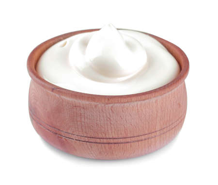 Mayonnaise in a wooden bowl on a white isolated background. white sauce. close-upの写真素材